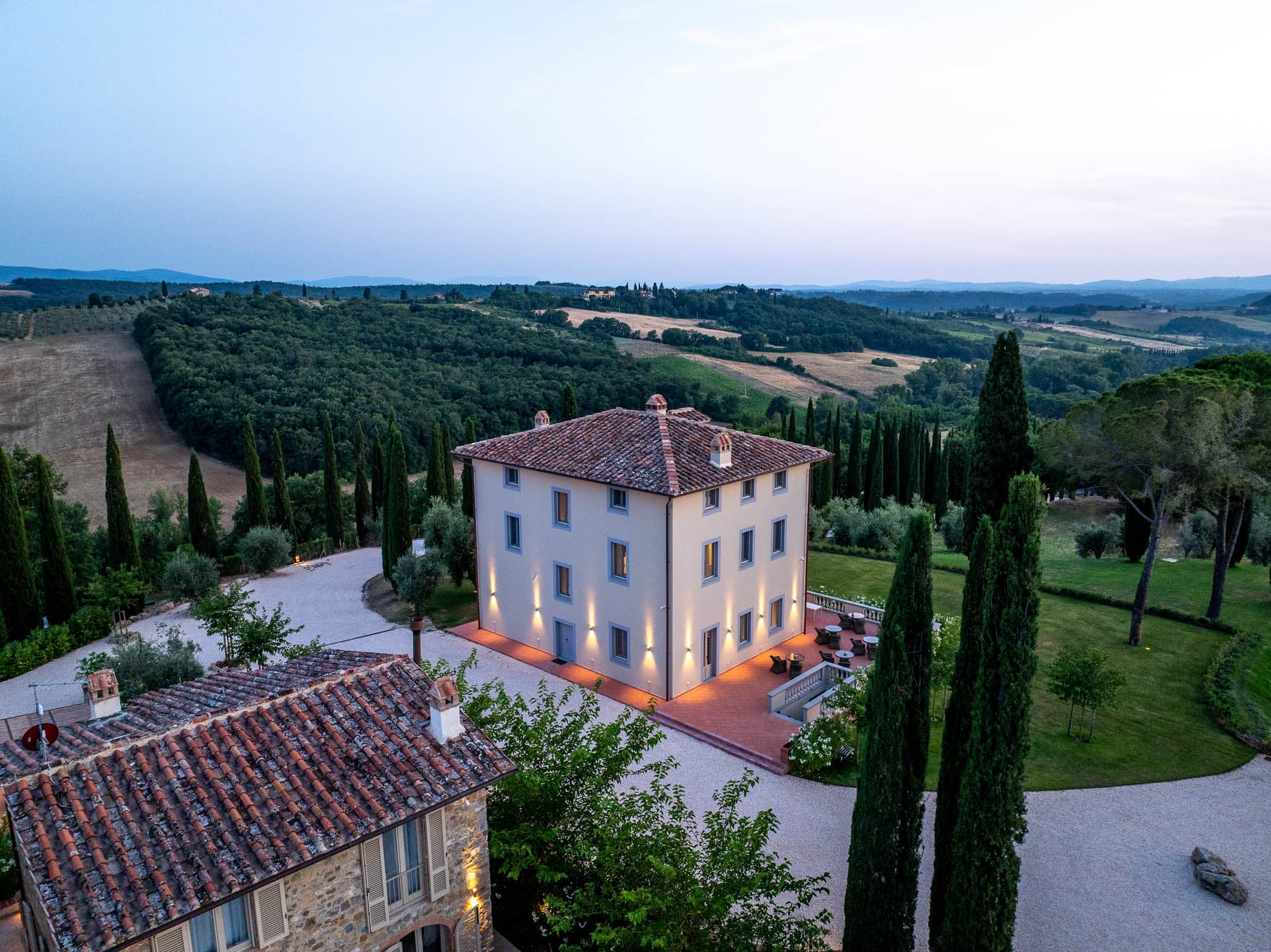 Tuscan villa at dusk with rolling hills
